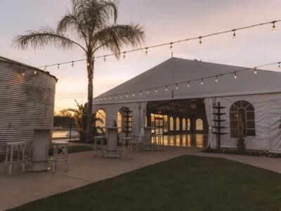 The Silos Event Center interior set up for a formal event with elegant lighting and lake views
